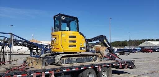 John Deere excavator on a trailer for transport