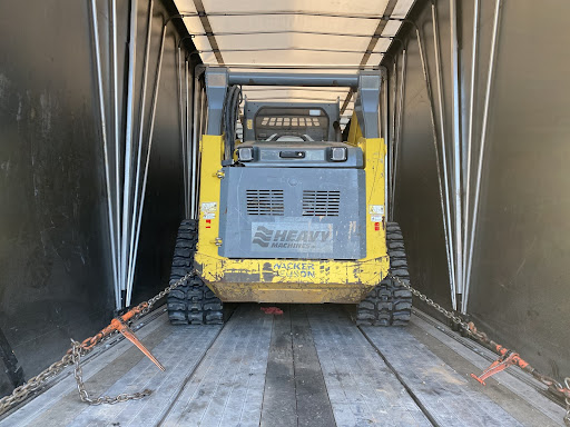 skid loader in enclosed trailer