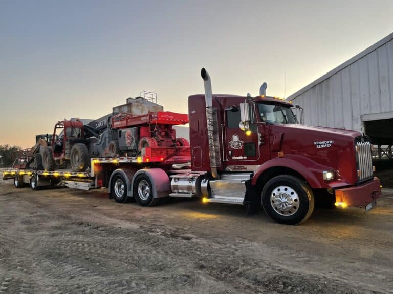 Transporting multiple heavy equipment on a step deck trailer