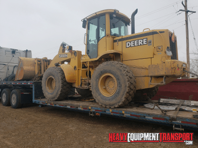 john deere wheel loader on step deck for transport