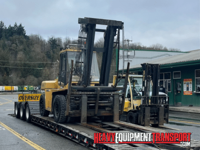 2006 Caterpillar DP115 25K Lbs Rough Terrain Forklift loaded on a Double Drop Trailer for transport