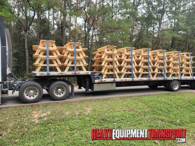 Picnic Tables loaded on a step deck trailer for transport