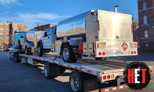 Ford F-550 Fuel Tanker loaded on a step deck trailer for transport