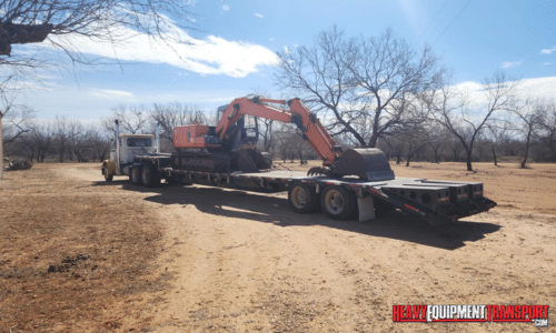 Shipping a long reach excavator on a flatbed trailer.