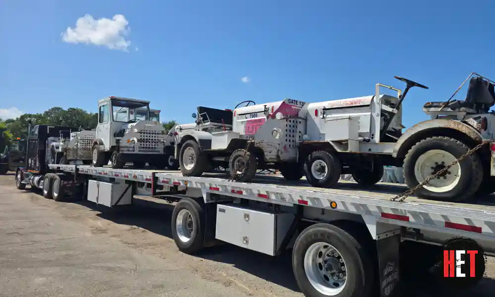 Airport baggage tractor transport on flatbed