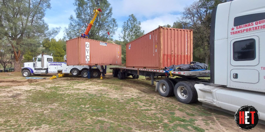 Containers being loaded onto trailer for transport.