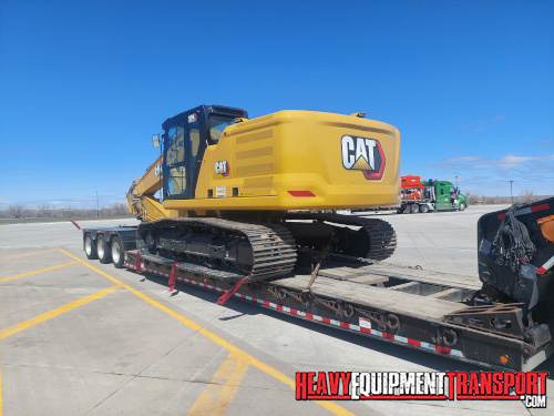 Transporting a CAT excavator on a lowboy trailer.