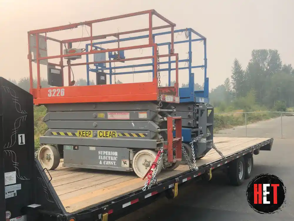 Transporting scissor lifts