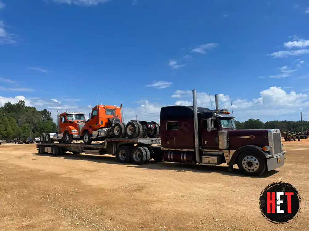 2 semi trucks being transported